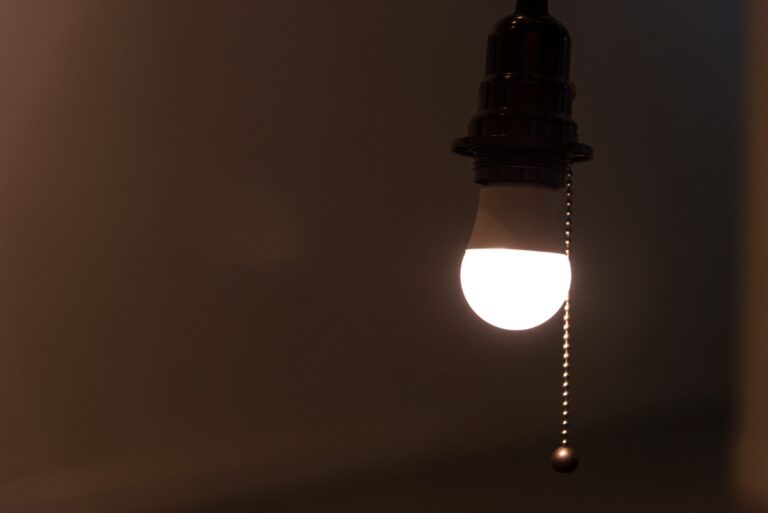 Une ampoule allumée dans une pièce sombre